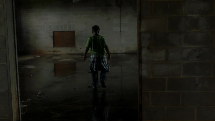Boy plays in the water in a leaky warehouse