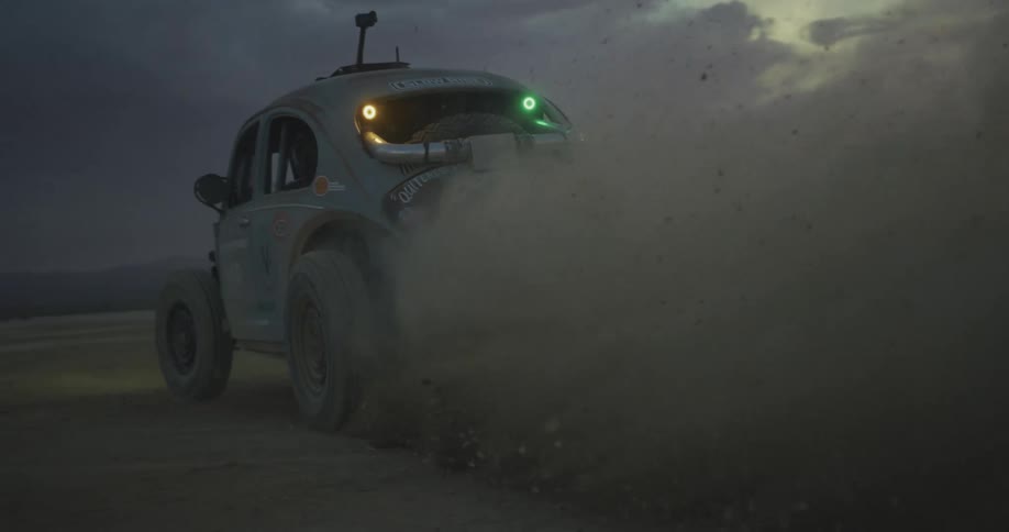 Car traveling on a snow and ice covered road leaving behind a trail of smoke