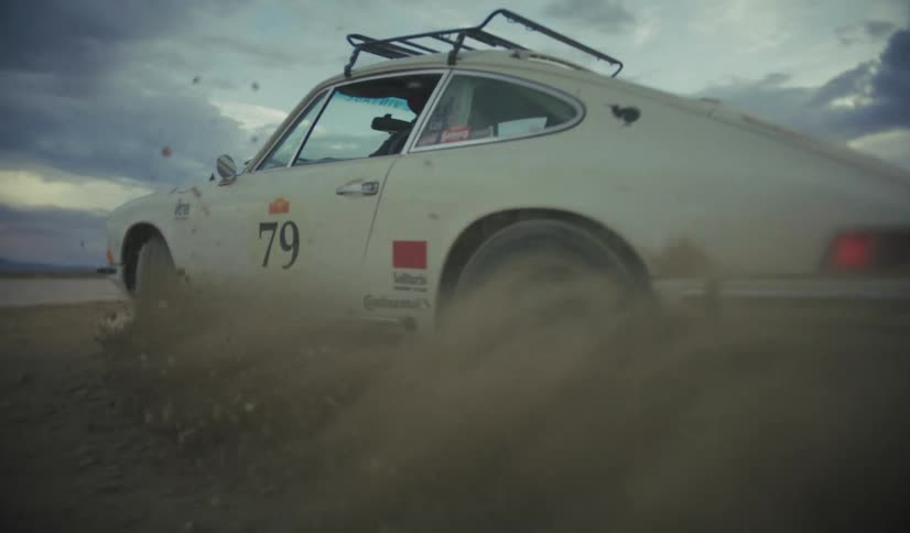 A car drifting in dirt on a sunny day
