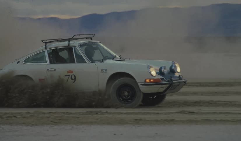 A man is doing donuts in the desert in his car
