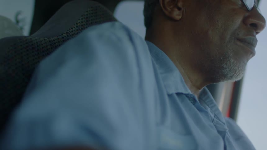 Close up of a man driving in a vehicle