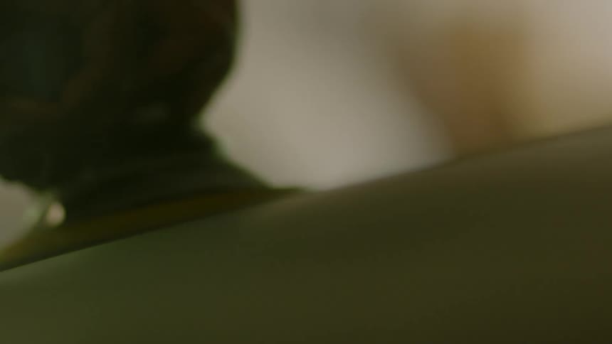 A hand moves a buffer across a surface