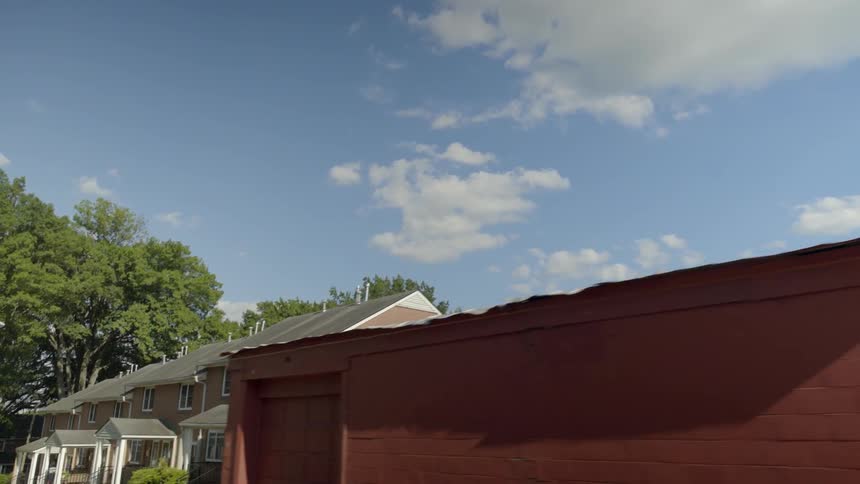 Moving past homes on a semi cloudy day
