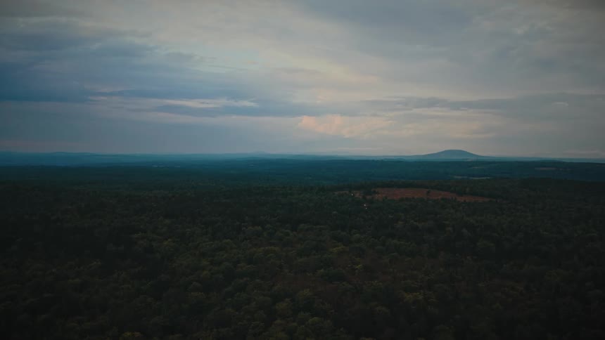Forest area with a mountain range on the background outdoors during day time