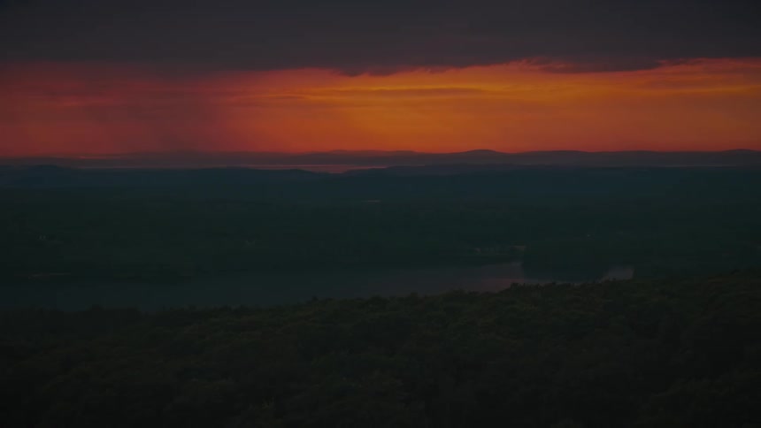 An aerial view of a sunset in the distance