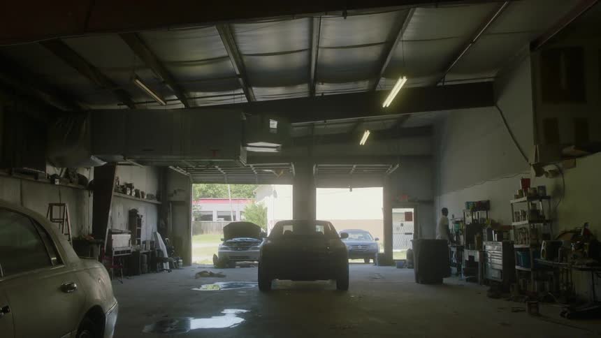 Cars sit in a mechanics garage