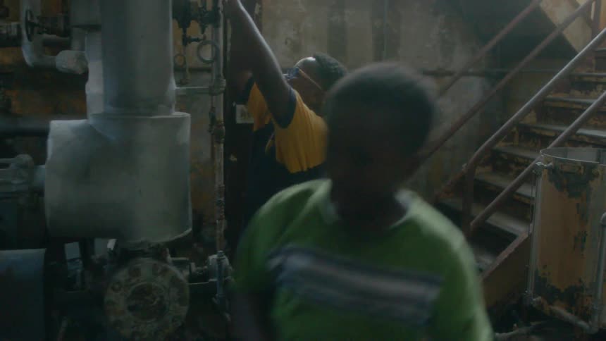 Children descend the stairs into a basement with machinery