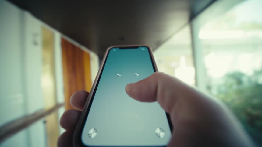 Hand holding a smartphone with thumb touching the screen