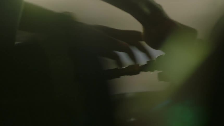 A man rubs a buffer over the hood of a car