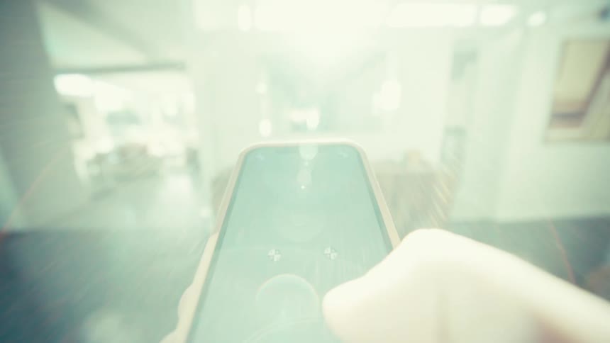 Man holds a smart phone in his hand moving his thumb across the screen