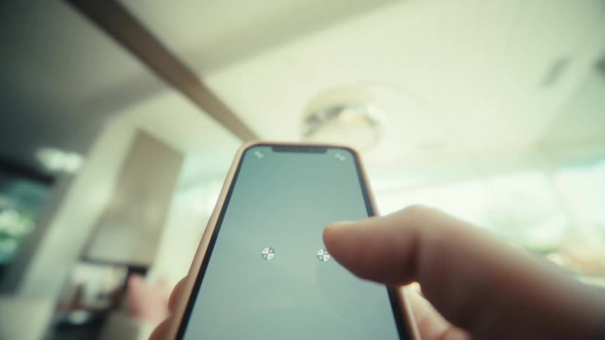 A person uses their phone as they move it down