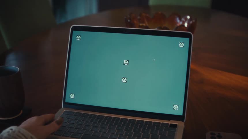Woman with painted nails types on a laptop