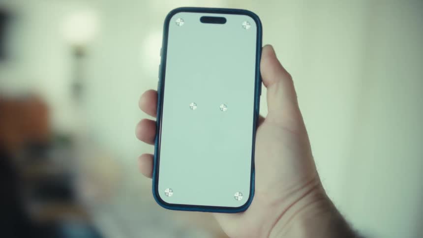 The person turns around with their phone in their hand