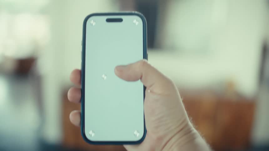 A person using a smartphone while walking around a house