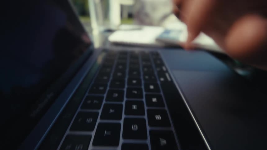 A person typing on a laptop