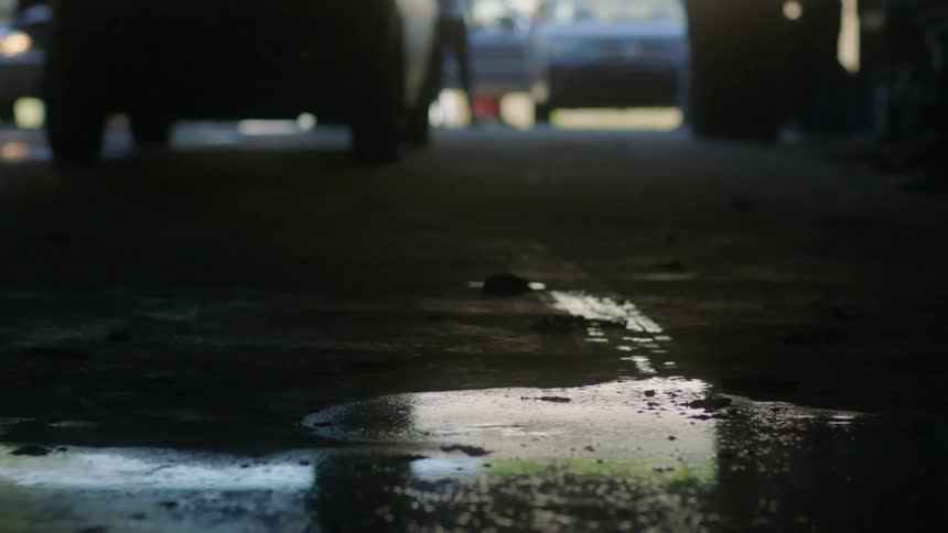 A person walks over a puddle on the ground