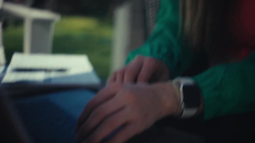A woman types on a laptop