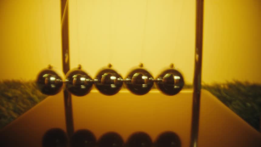 A view of a newtons cradle ball game in an office