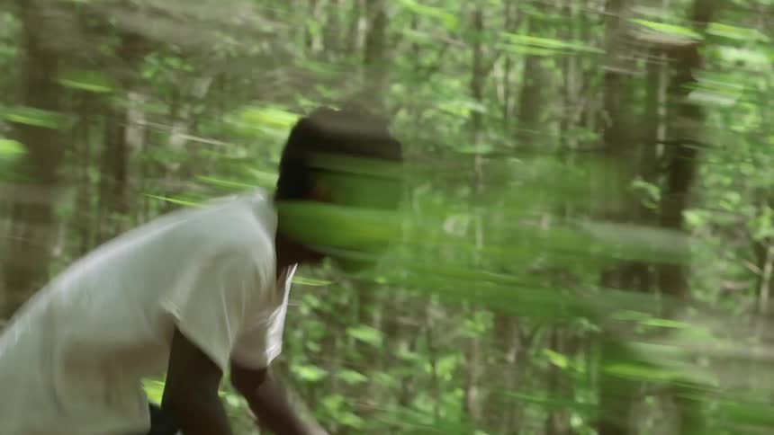 Man riding a bicycle through the woods