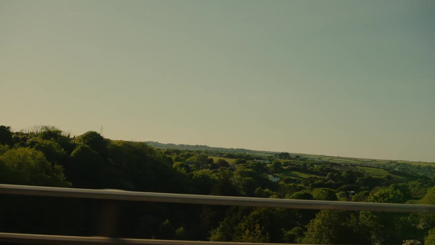 Moving across a highway overlooking a forested valley