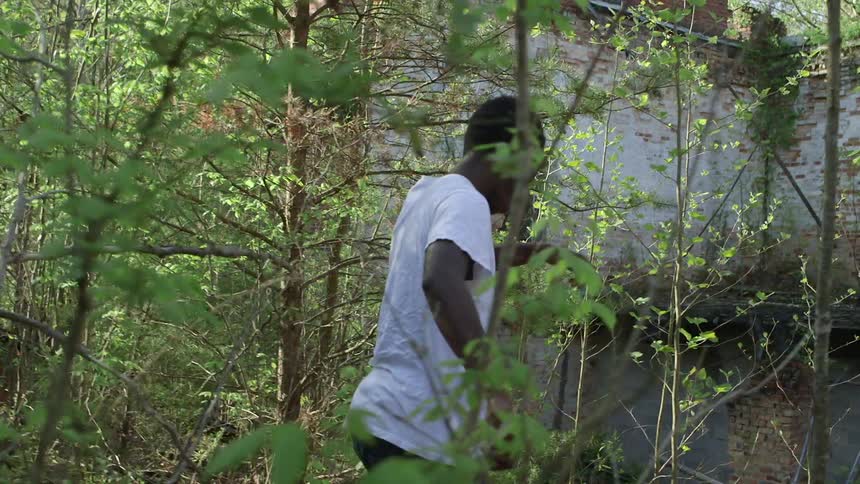 Man walks through a wooded area