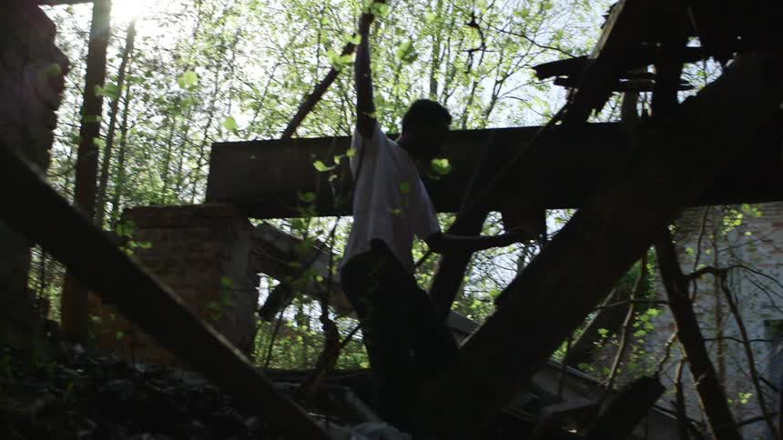 A man walks through the demolished home
