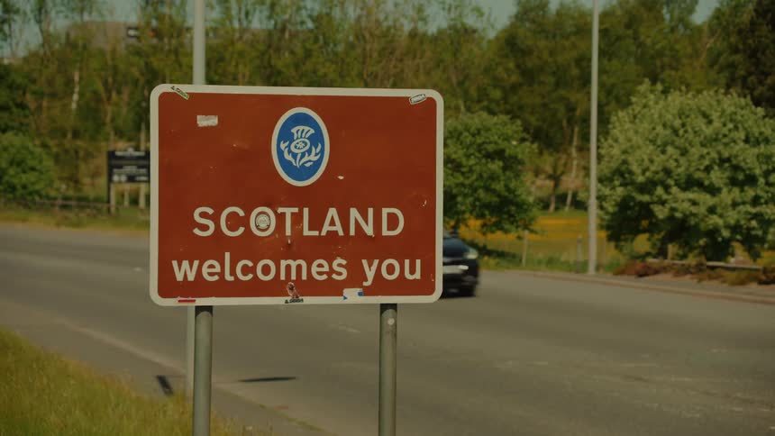 A view of cars driving by a sign