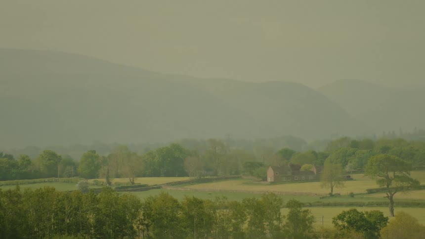 A view of a landscape with grass and hills