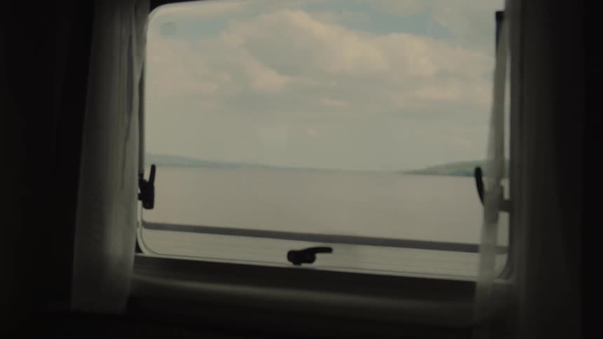 The view from a window shows a bridge crossing a waterway