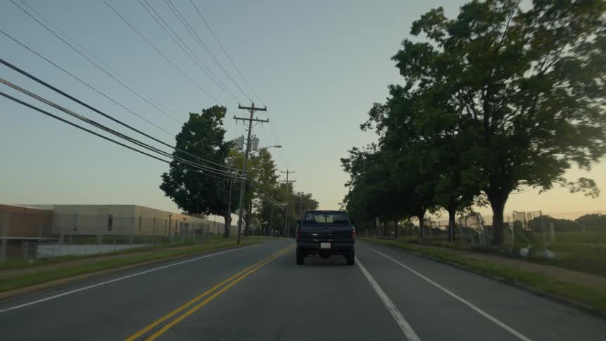 A truck drives on a rural road