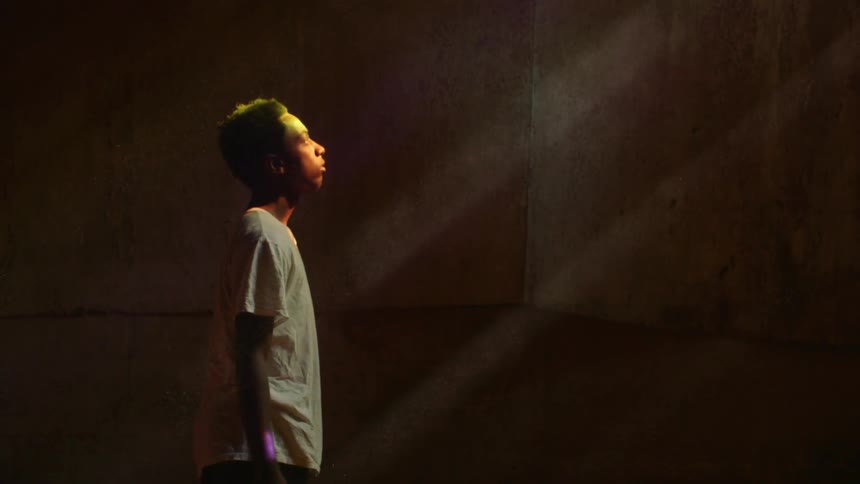 A man looks up at the sun streaming into a room
