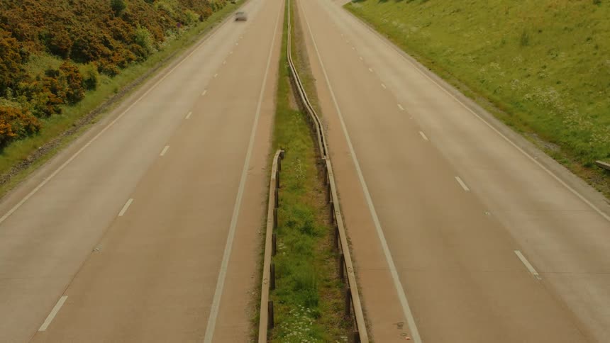 Dual carriageway seen from above with vehicles in motion