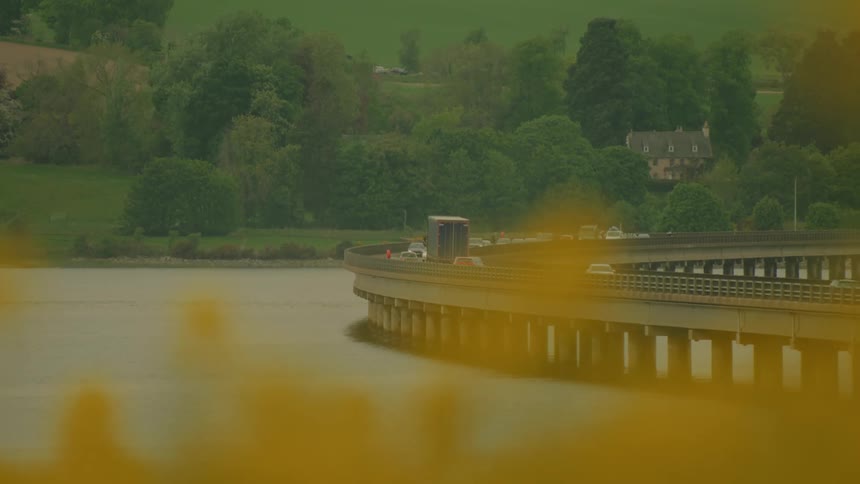 Traffic moves across a bridge spanning a waterway