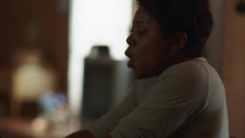 A man and woman argue while sitting at a table