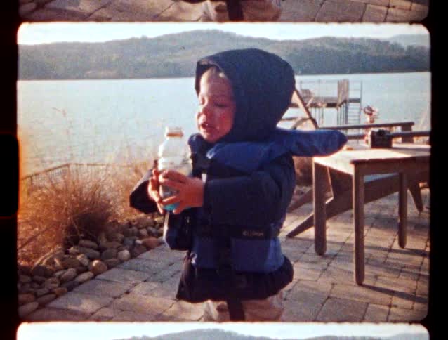 A child standing outdoors on a winter day in a jacket