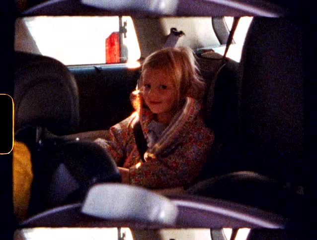 Children in car seats are riding in a car listening to music