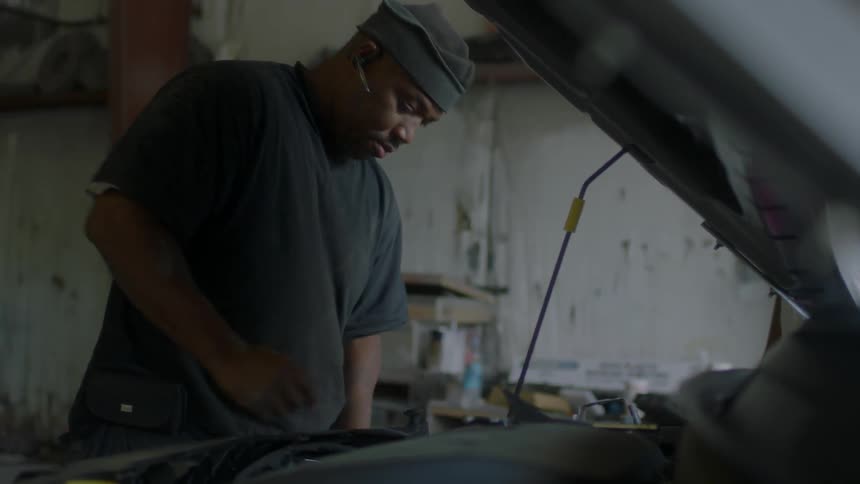 Man works on a car in a garage