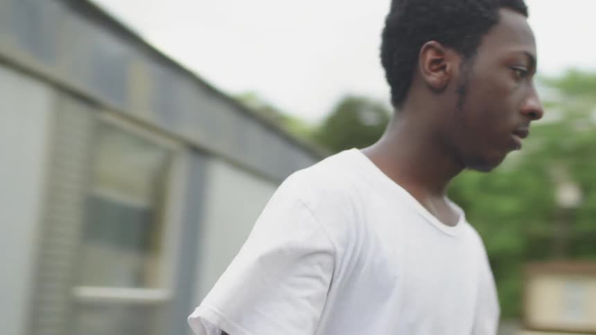 Man opens the front door and walks outside in a trailer park