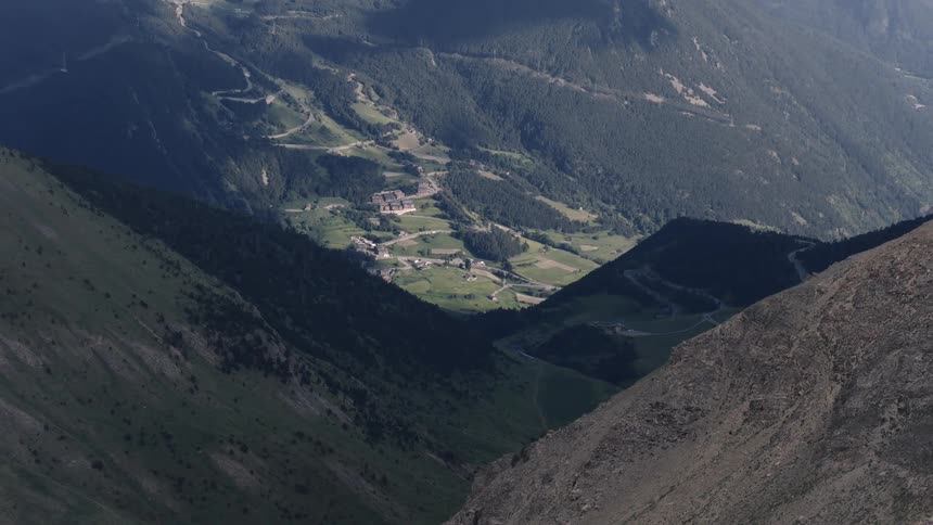Aerial view of a rural neighborhood in a forested mountain valley