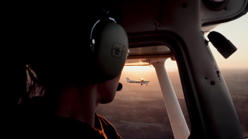 A woman flying a plane on a sunny day