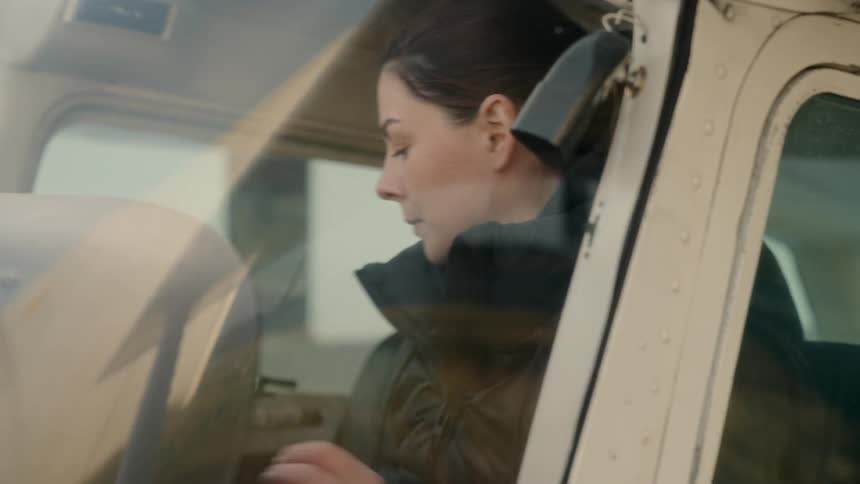 Person seated in aircraft looking out window