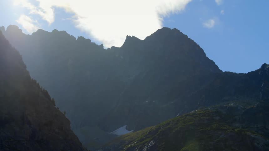 The tall mountains are covered with green