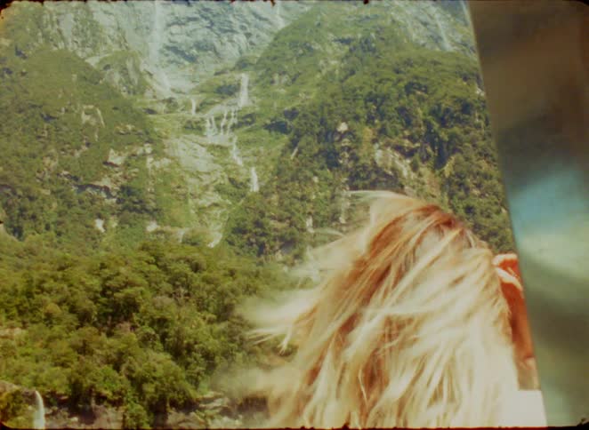 A woman with her head out of the window of a vehicle