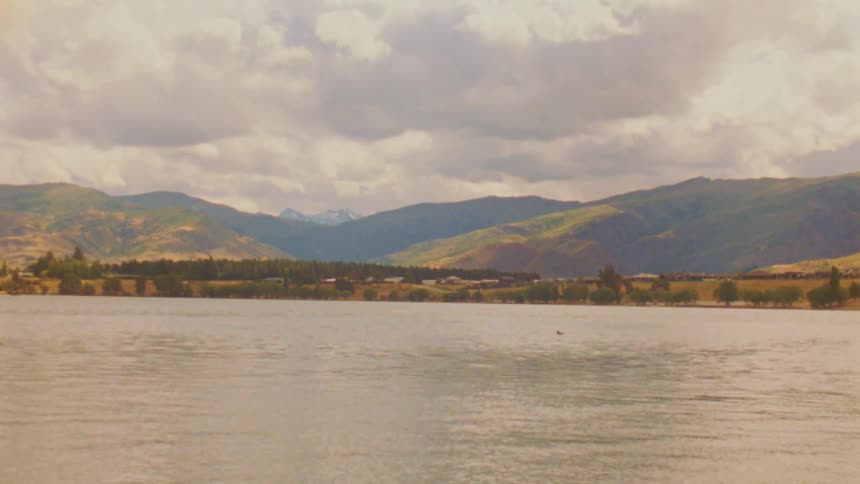 A view of a lake with mountains in the distance
