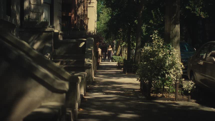 Couple walking along treelined street
