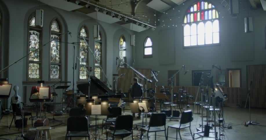 Man walks around a makeshift stage in a church