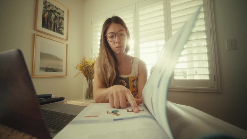 A woman reading a book in a room