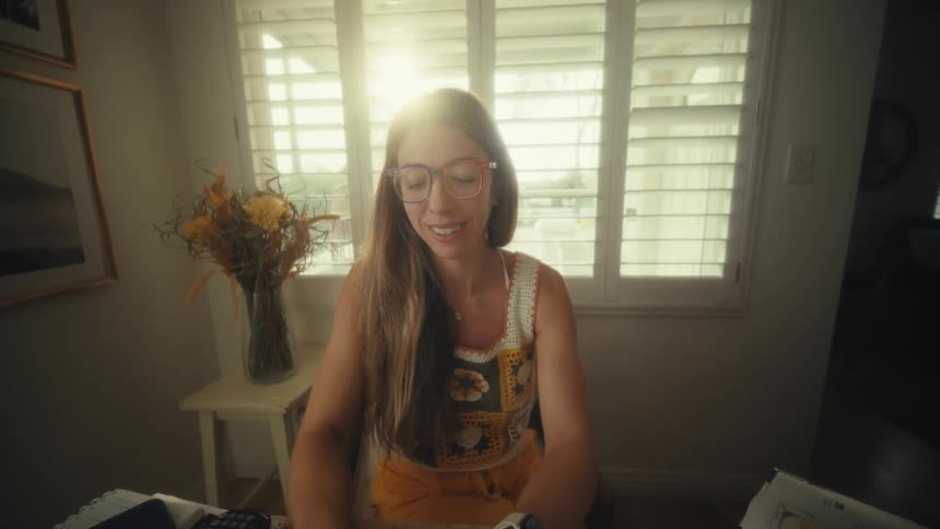A woman using a laptop in a room
