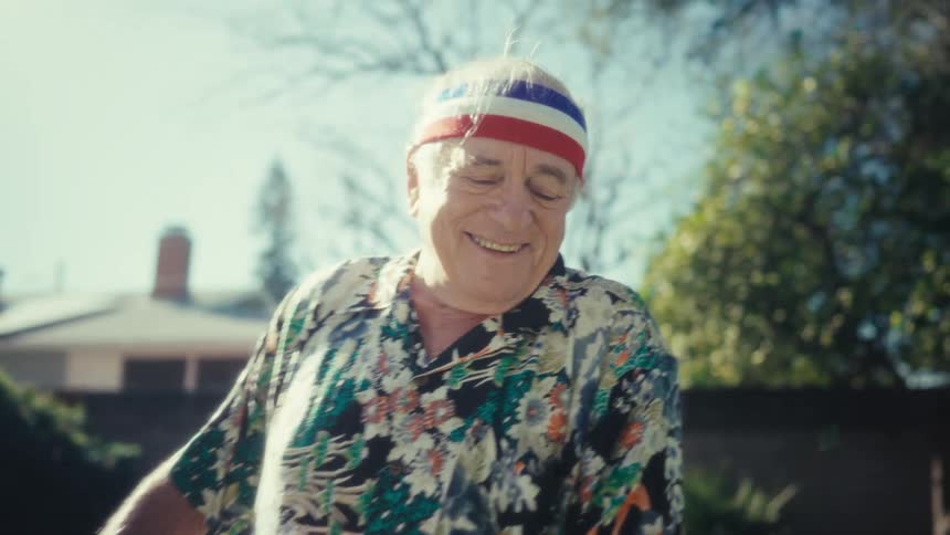 A man dancing outdoors in a backyard