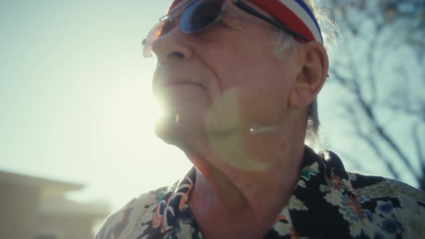 Elderly man wears a sports headband